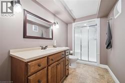Wood-finish vanity with an integrated sink and light-toned countertop -