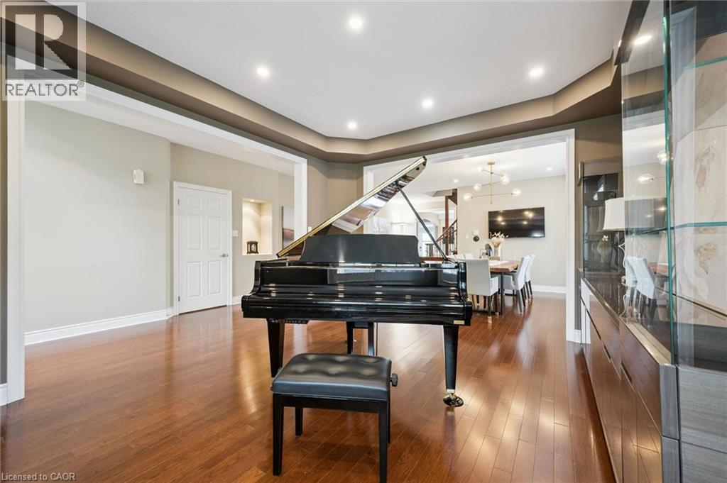 Rich wood-finish flooring, recessed ceiling lighting, a coved ceiling, and wide doorway openings - 517 Topper Woods Crescent, Kitchener, ON