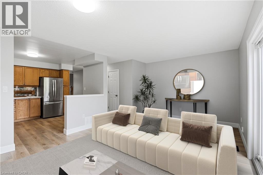Kitchen with wood cabinetry, stainless steel refrigerator, and wood-finish flooring - 30 S Imperial Road Unit# 3, Guelph, ON