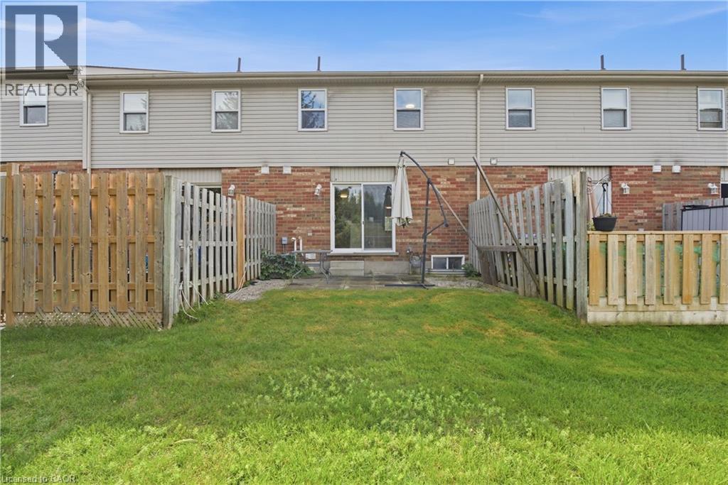 Private fenced yard with patio area and sliding glass door access - 30 S Imperial Road Unit# 3, Guelph, ON