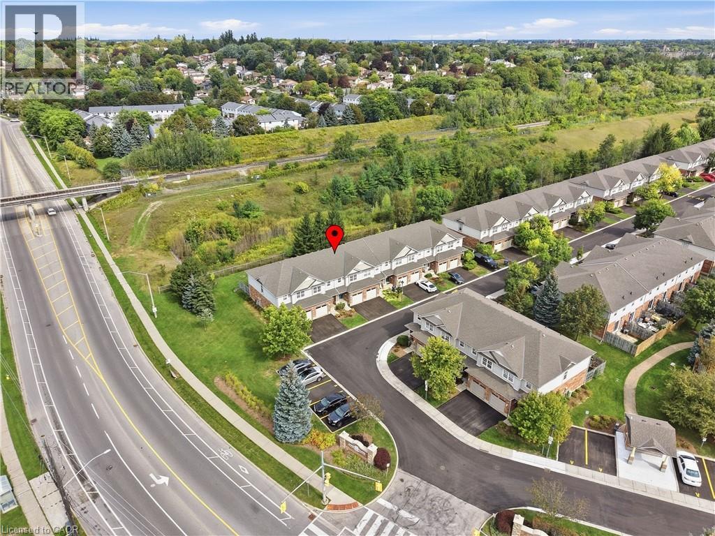 Townhome community featuring private driveways, paved roadways, and landscaped grounds - 30 S Imperial Road Unit# 3, Guelph, ON