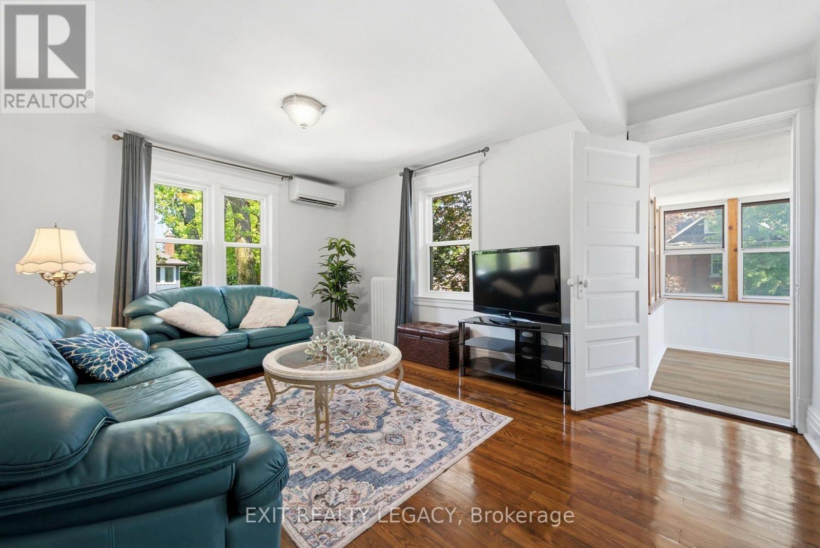 Suite 2 living room with restored 1920s hardwood - 126 Temperance Street, Aurora, ON
