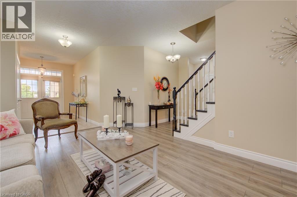 Light wood-finish flooring, white baseboards, and neutral wall tones create an inviting atmosphere - 78 Stuckey Avenue, Baden, ON