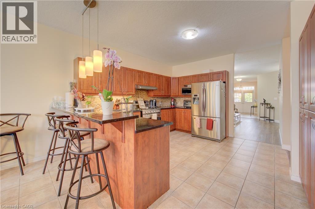 Tiled flooring, multiple large windows, and a sliding glass door - 78 Stuckey Avenue, Baden, ON
