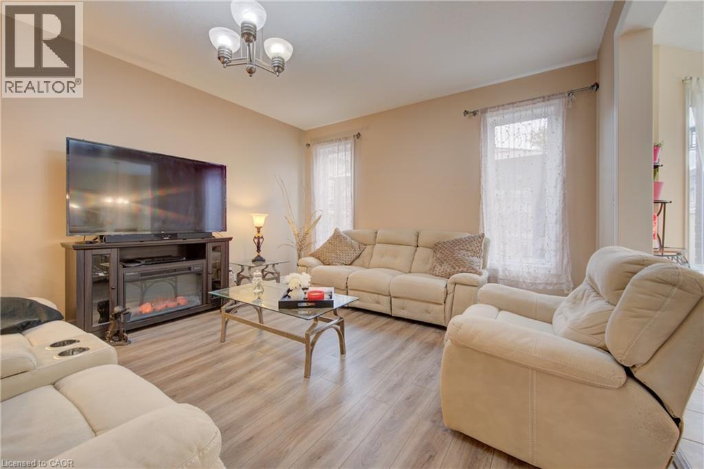 Open concept living space featuring wood-finish flooring, recessed lighting, and a chandelier - 78 Stuckey Avenue, Baden, ON