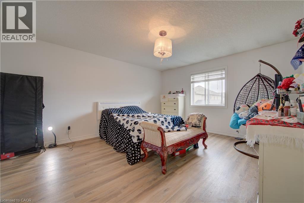 Wood-finish flooring throughout, bright white walls, and a window with blinds - 78 Stuckey Avenue, Baden, ON