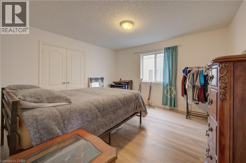 Light wood-finish flooring, double panel doors, and a window for natural illumination - 78 Stuckey Avenue, Baden, ON
