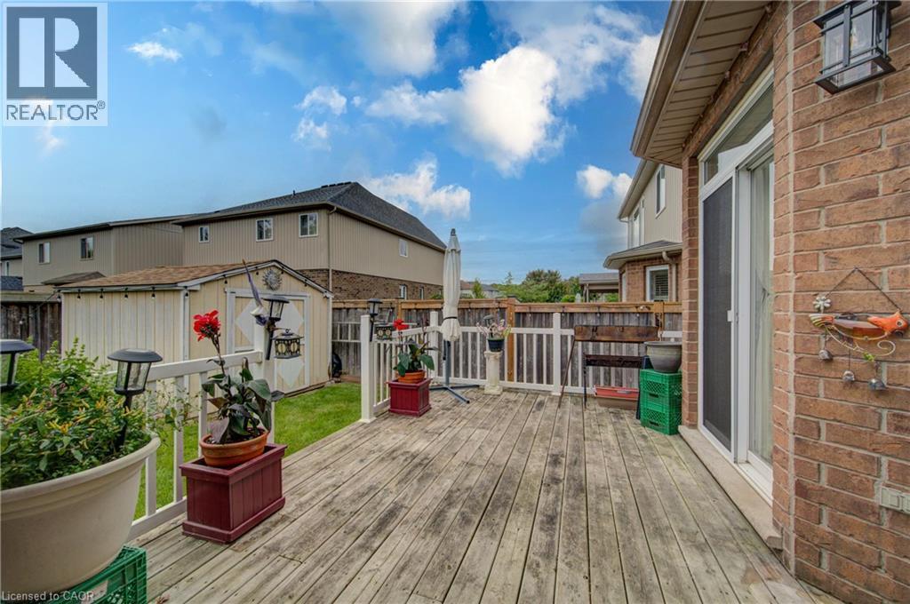Expansive wood deck with white railing, brick exterior, and direct access to the interior - 78 Stuckey Avenue, Baden, ON