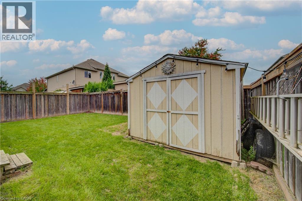 Expansive lawn area featuring a wooden storage shed, wood fence - 78 Stuckey Avenue, Baden, ON
