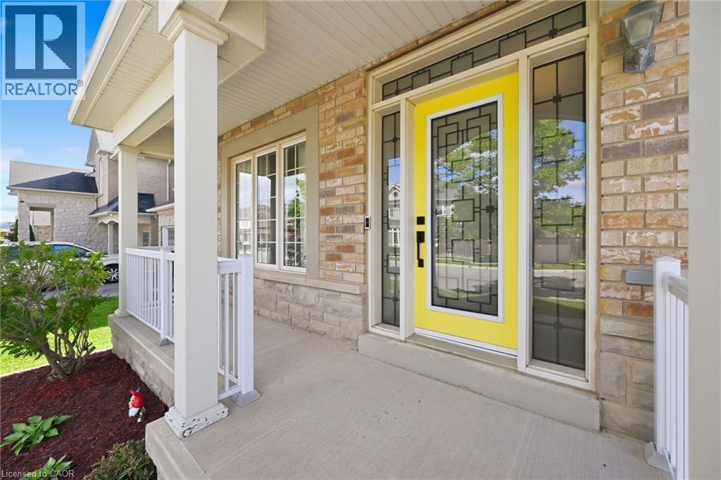 Brick and stone exterior with a covered porch - 3198 Tim Dobbie Drive, Burlington, ON