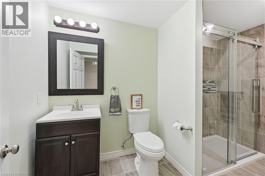 Wood-finish vanity with an integrated sink and brushed nickel faucet - 3198 Tim Dobbie Drive, Burlington, ON