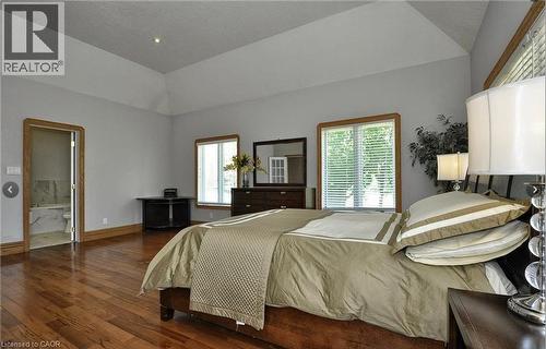 Tray ceiling with recessed lighting, rich wood-finish flooring, and natural wood trim throughout - 915 Briardean Road, Cambridge, ON 