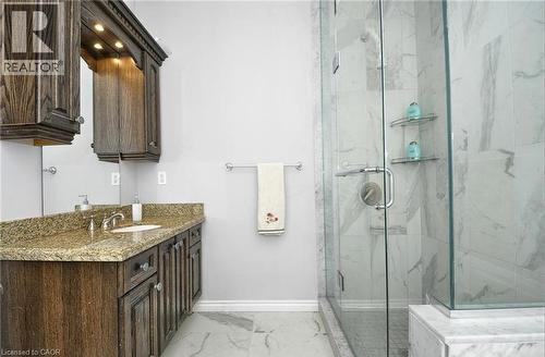 Dark wood-finish vanity with an undermount sink and granite countertop - 915 Briardean Road, Cambridge, ON 