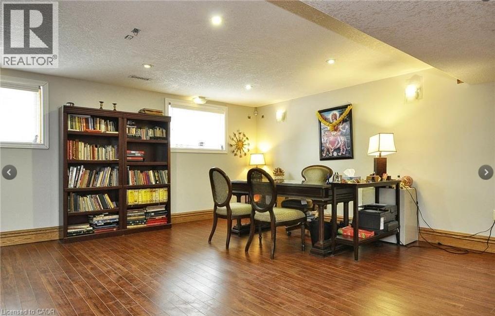 Recessed ceiling lighting, wood-finish flooring, two windows, wall sconces, and crown molding - 915 Briardean Road, Cambridge, ON