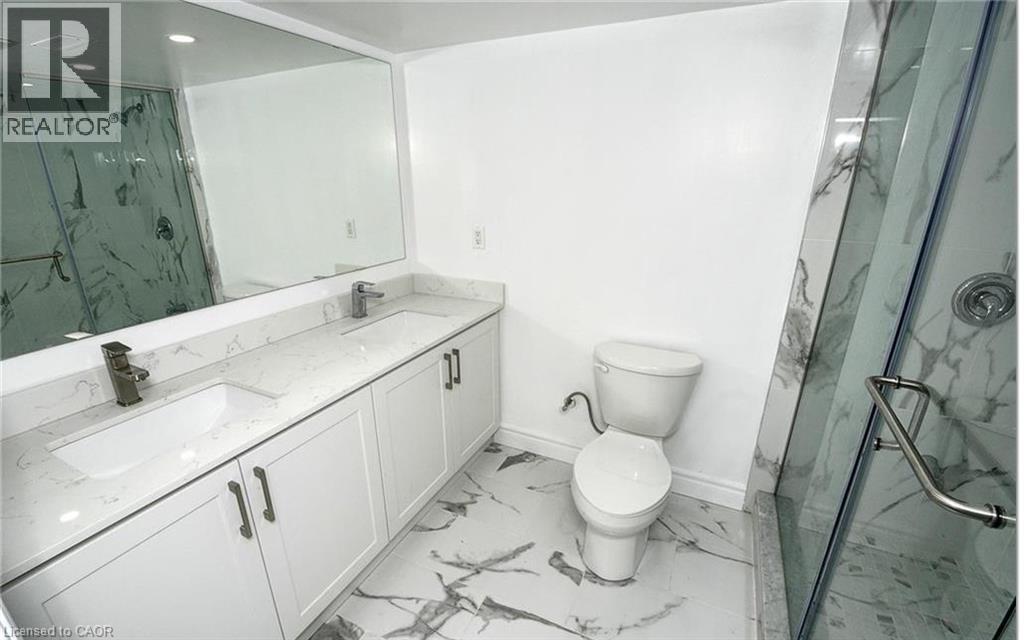 Dual sink vanity with white cabinetry and light-toned countertops - 915 Briardean Road, Cambridge, ON