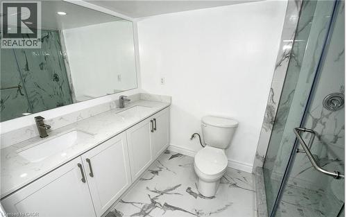 Dual sink vanity with white cabinetry and light-toned countertops - 915 Briardean Road, Cambridge, ON 