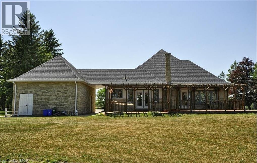 Stone exterior with a shingled roof - 915 Briardean Road, Cambridge, ON