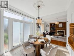 Open concept dining area with sliding glass doors, tile flooring, and a decorative ceiling medallion -