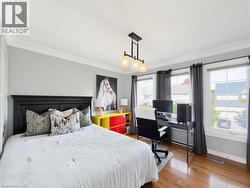 Crown molding, recessed lighting, wood-finish flooring, and multiple windows -