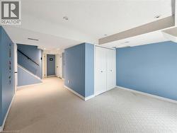 Carpeted flooring, recessed lighting, white baseboards, and built-in closet with bi-fold doors -