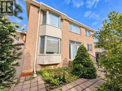 Brick exterior with multiple windows, a bay window, and sliding glass doors -