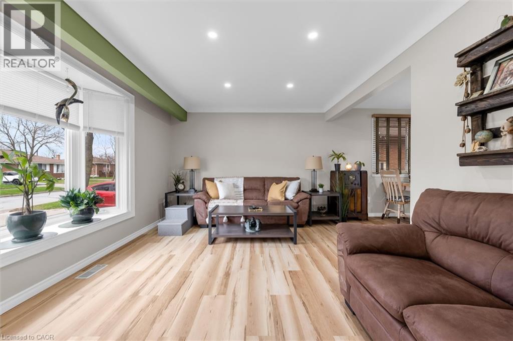 The living area features light-toned flooring, recessed lighting, and a bay window providing natural light - 7506 Jubilee Drive, Niagara Falls, ON