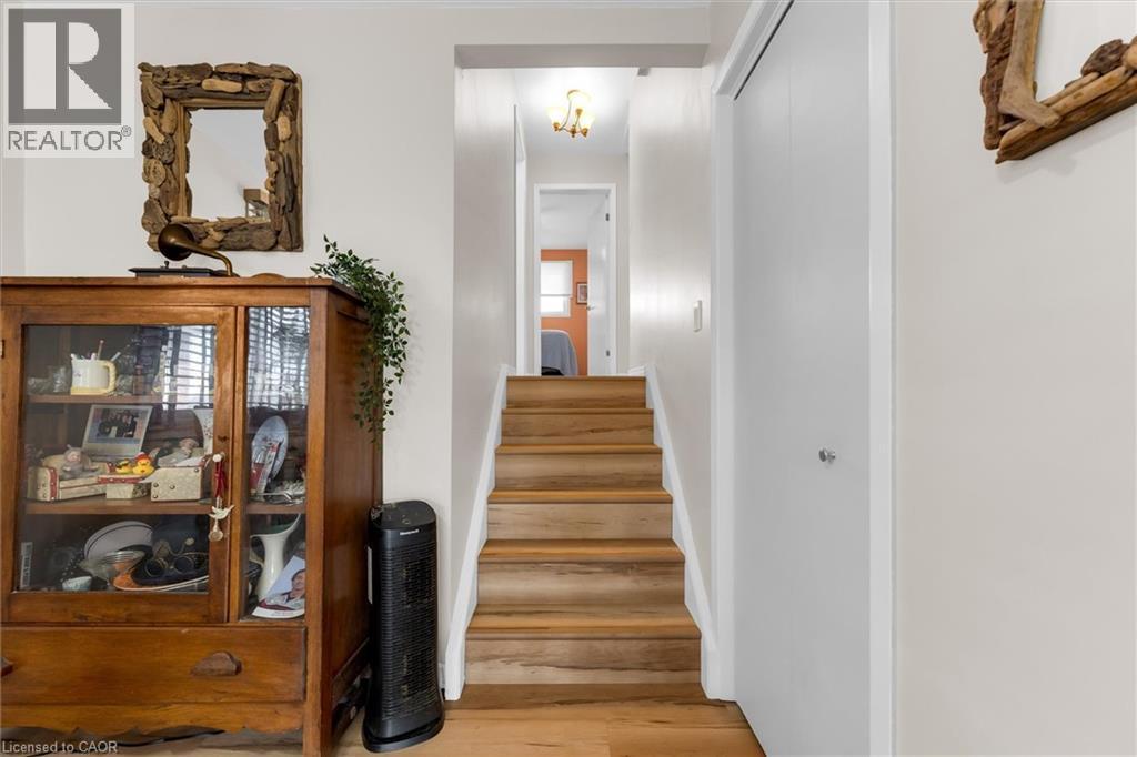 Hardwood stairs with a white railing leading to an upper level - 7506 Jubilee Drive, Niagara Falls, ON