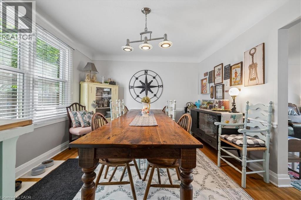 Hardwood flooring, multiple windows with blinds, recessed lighting, and a built-in credenza - 80 Maclennan Avenue, Hamilton, ON