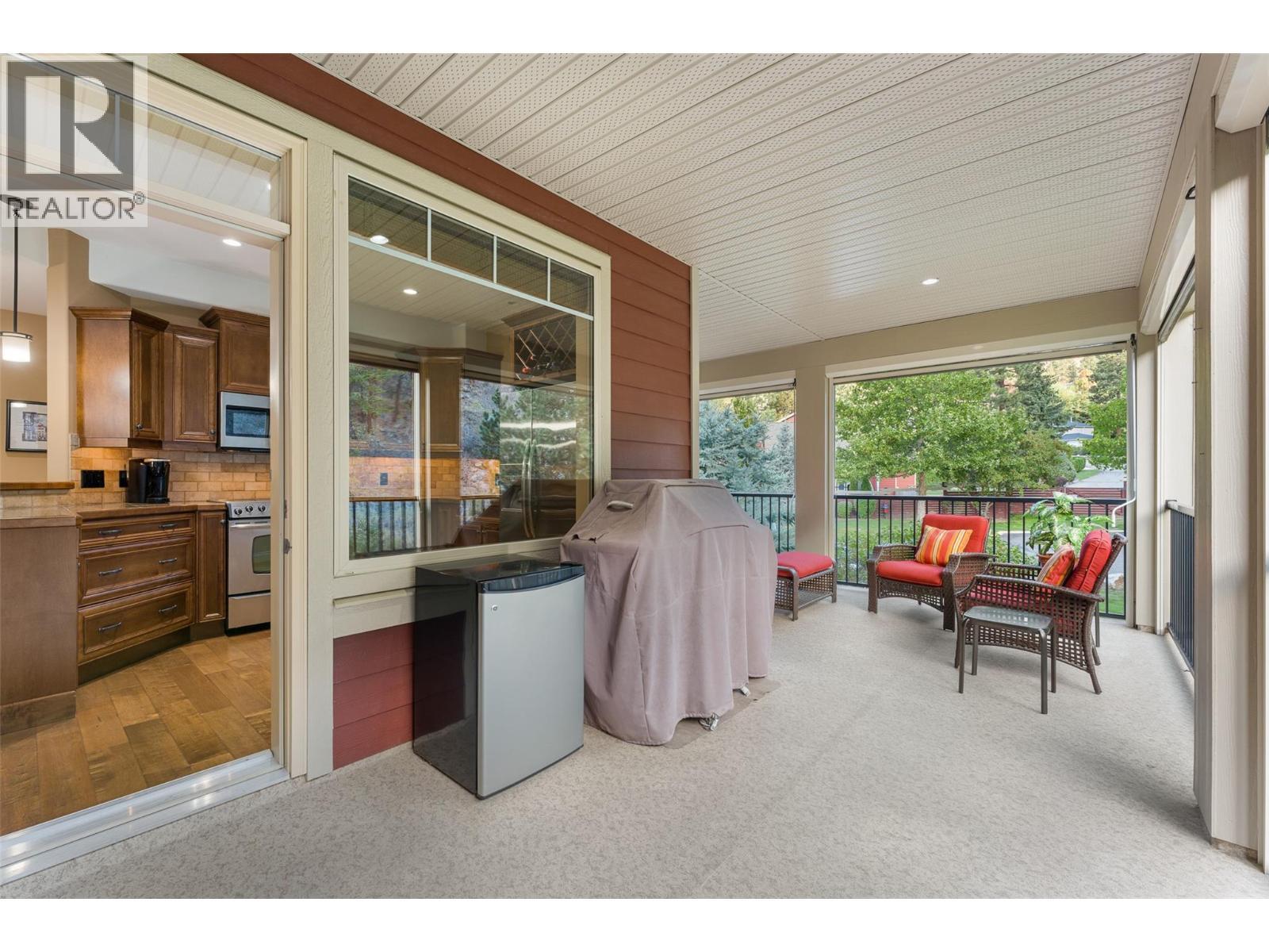 Walk out of the kitchen straight onto your private covered deck. - 2780 Auburn Road Unit# 203, West Kelowna, BC