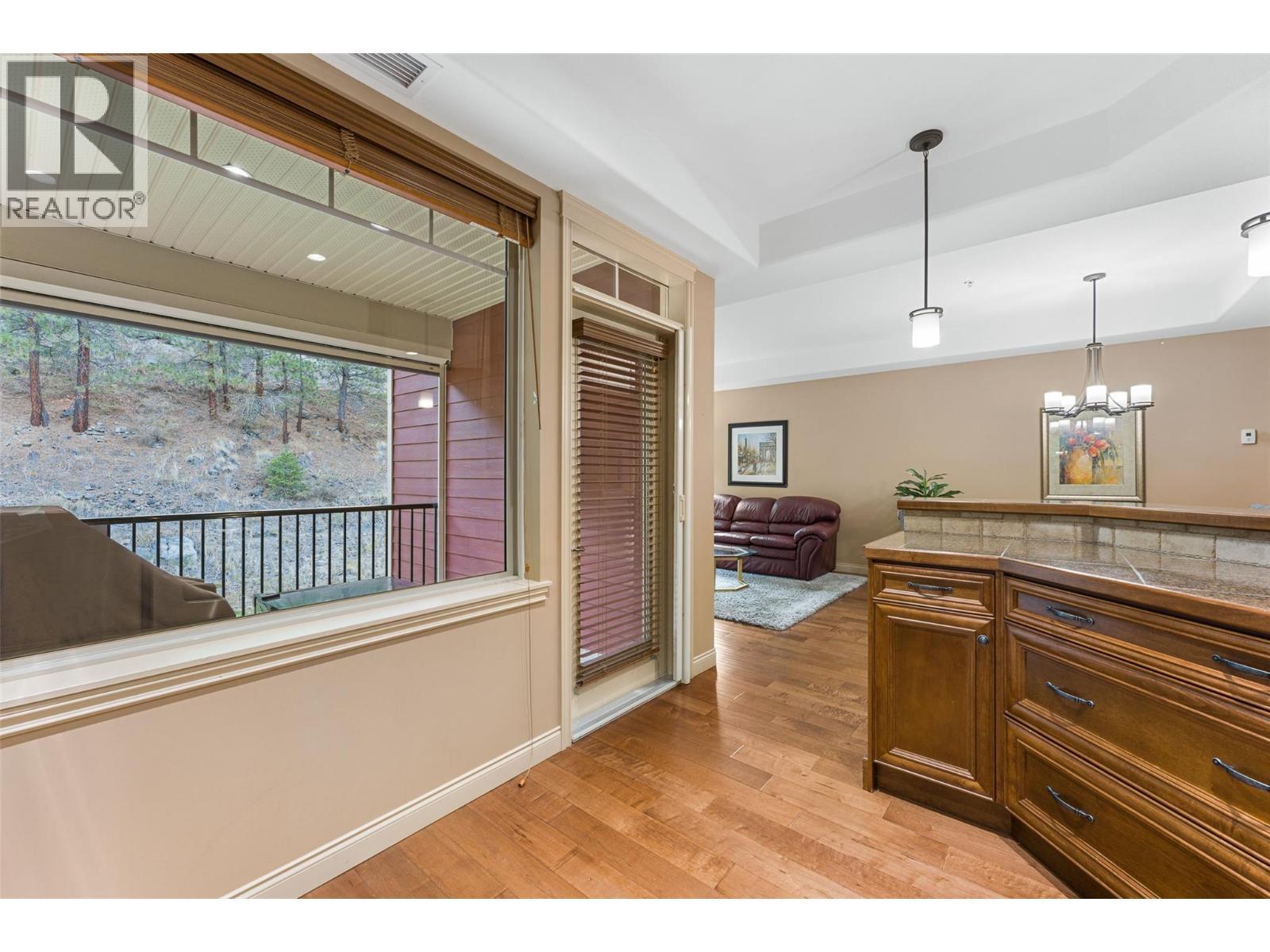 Kitchen access to the covered deck. - 2780 Auburn Road Unit# 203, West Kelowna, BC