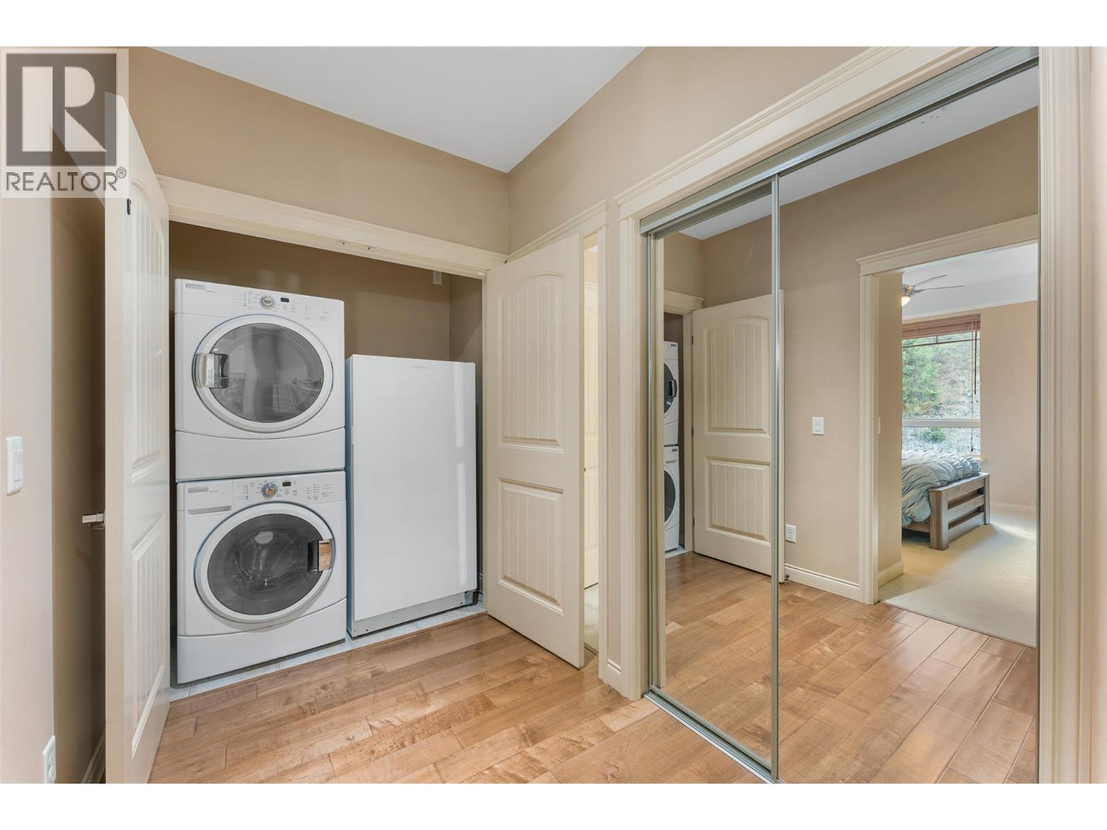 Stacked in-unit laundry plus an included upright freezer. - 2780 Auburn Road Unit# 203, West Kelowna, BC