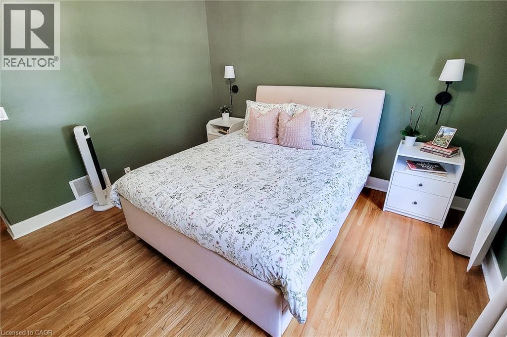 Hardwood flooring throughout, featuring white trim and green wall finishes - 19 Thorndale Avenue, St. Catharines, ON