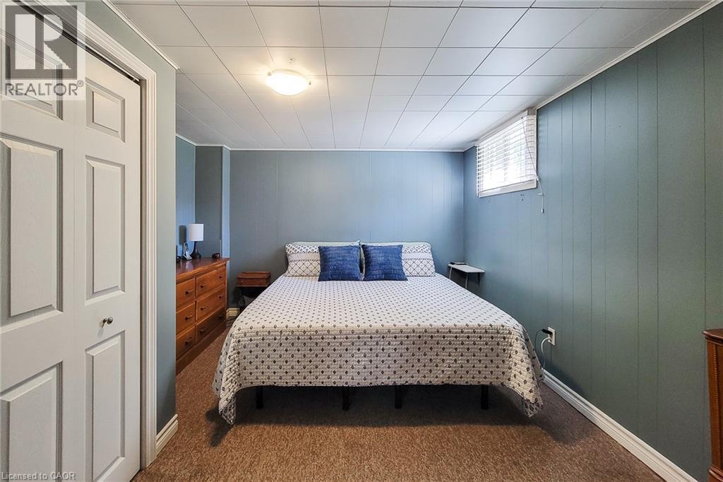 Panel accent wall, suspended ceiling, window with blinds, bi-fold closet, recessed lighting - 19 Thorndale Avenue, St. Catharines, ON