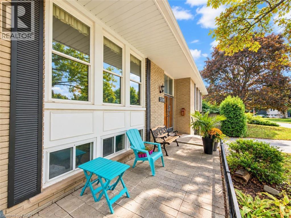 Brick exterior with multiple windows and dark louvered shutters - 2490 Yarmouth Crescent, Oakville, ON
