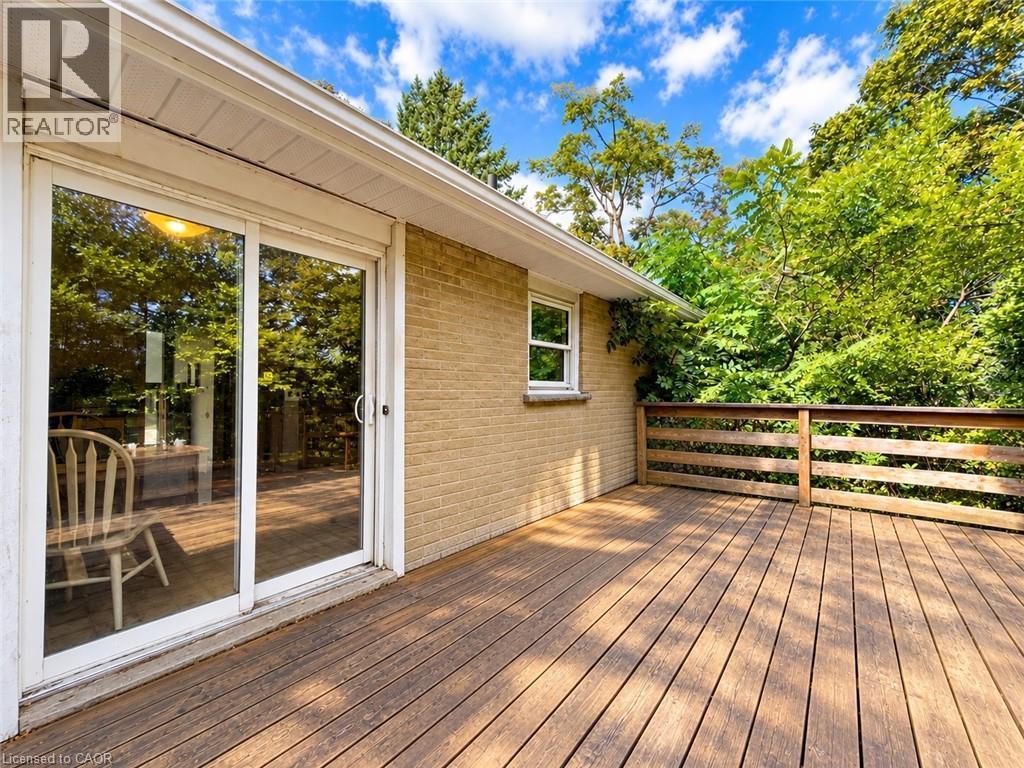Expansive wooden deck with a slatted railing, providing an outdoor extension to the living space - 2490 Yarmouth Crescent, Oakville, ON