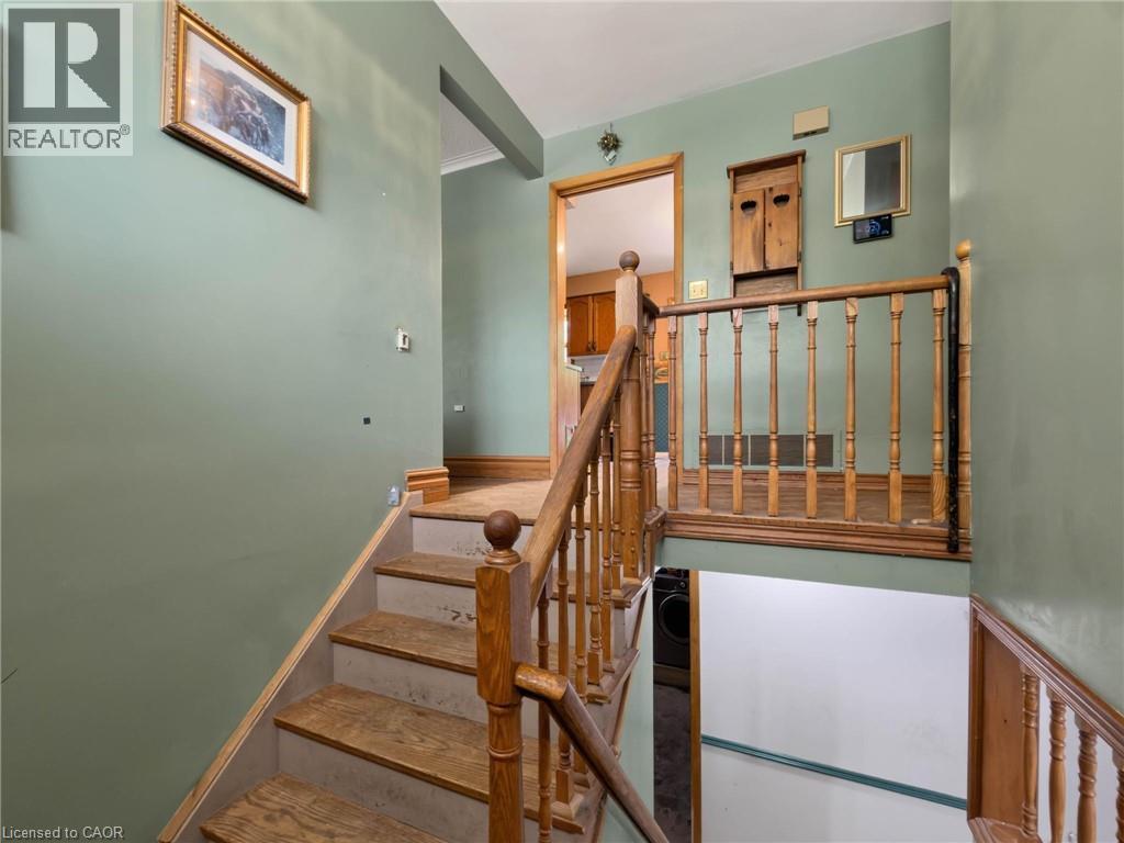 Wood-finish stairs with classic wood balusters and railing - 2490 Yarmouth Crescent, Oakville, ON