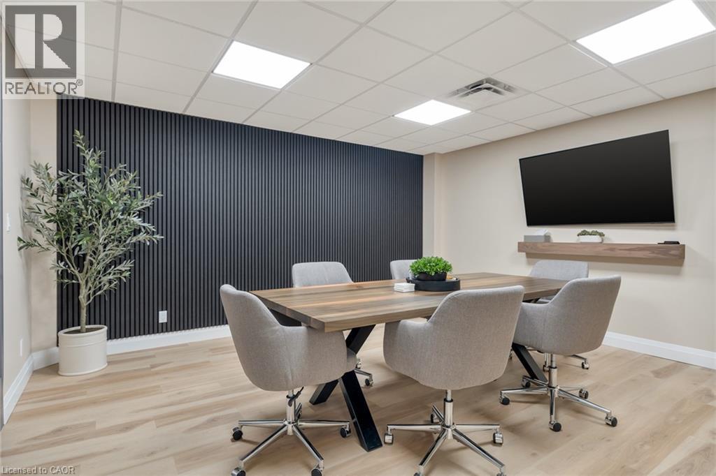 Wood-finish flooring with a contrasting dark accent wall - 23 Market Street W, Port Dover, ON