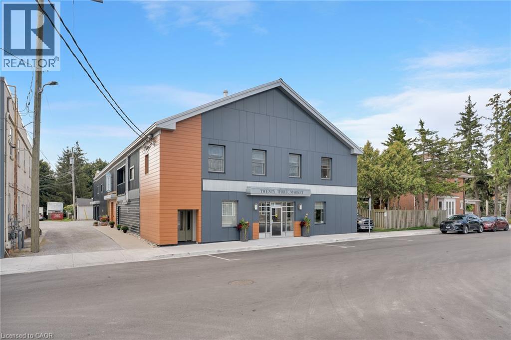 Modern multi-story facade featuring varied siding and an awning - 23 Market Street W, Port Dover, ON