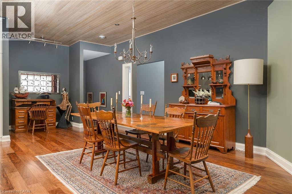 Wood-finish flooring with baseboard trim, complemented by a wood-paneled ceiling - 23 Market Street W, Port Dover, ON