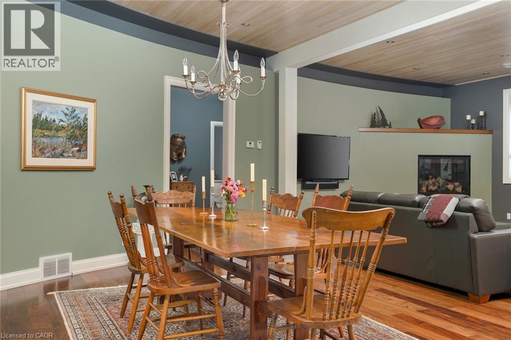 Hardwood flooring, painted walls with trim, built-in fireplace, recessed lighting, and a wood-finish ceiling - 23 Market Street W, Port Dover, ON