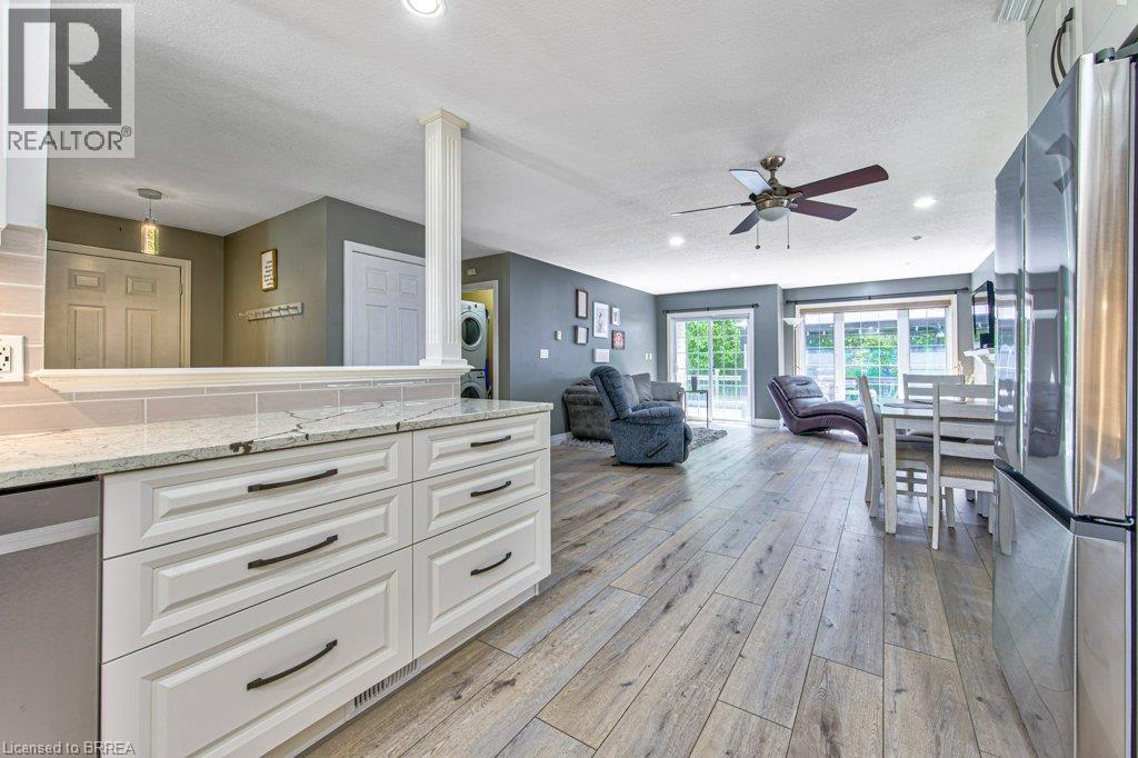 Kitchen featuring white cabinetry, light-colored countertops, and a tile backsplash - 423 Poldon Drive, Norwich, ON