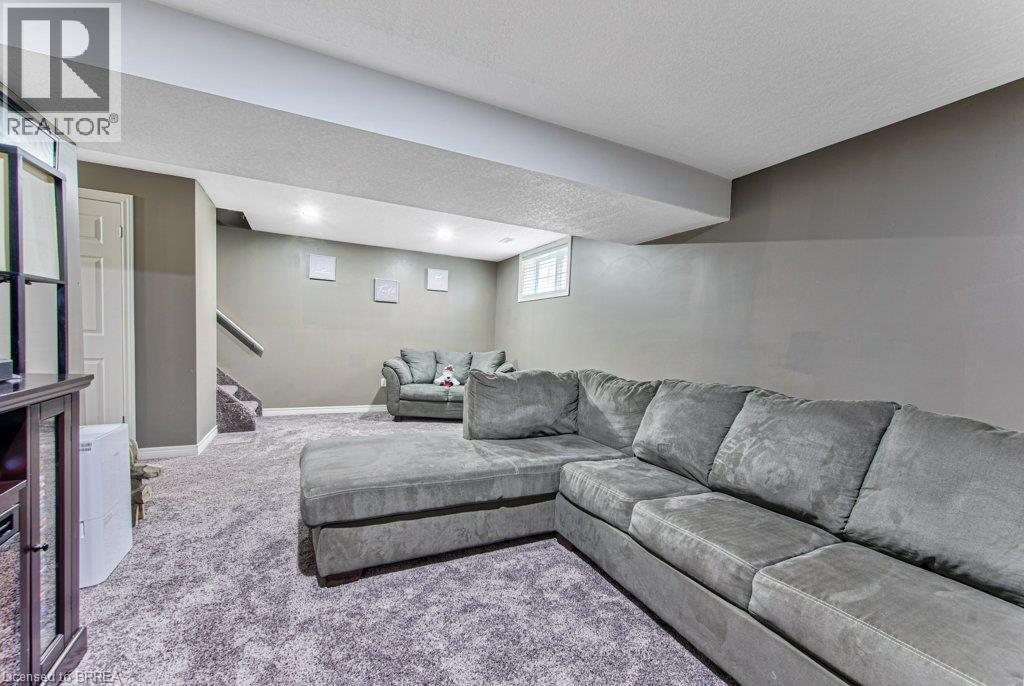 Recessed lighting illuminates the carpeted flooring and painted walls - 423 Poldon Drive, Norwich, ON