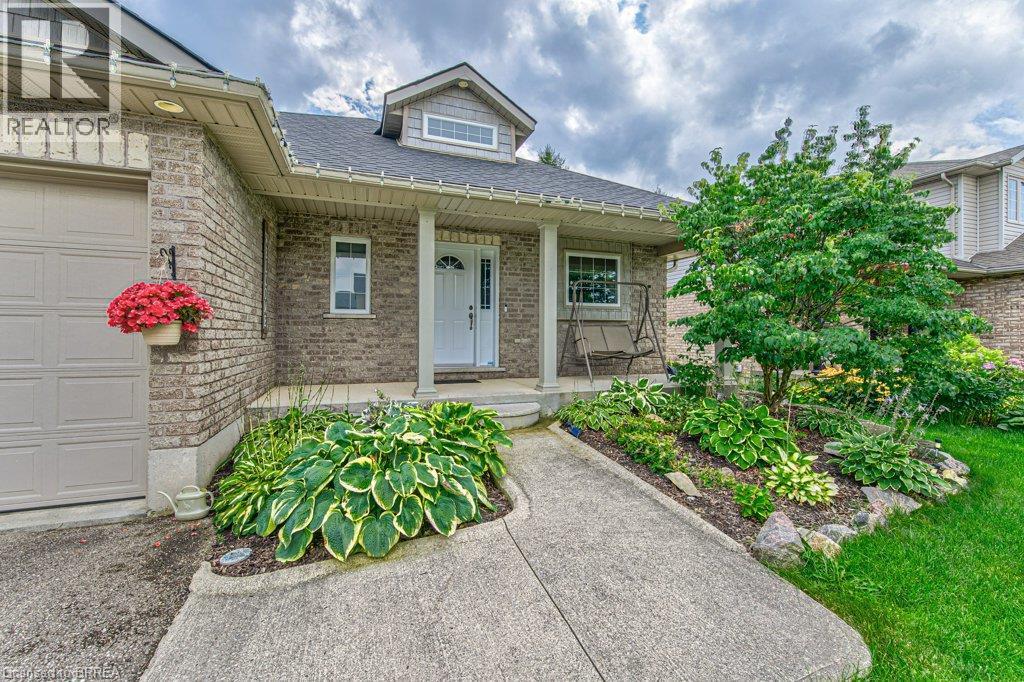 Brick facade with an integrated garage door - 423 Poldon Drive, Norwich, ON