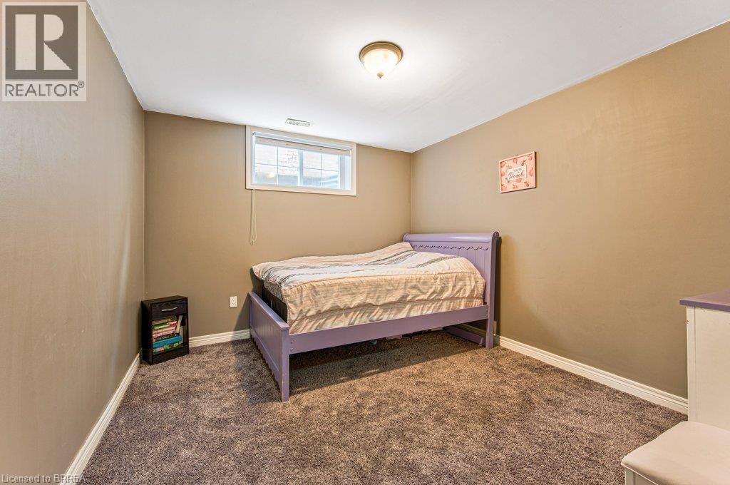 Textured carpeting, recessed window, and flush mount ceiling light fixture - 423 Poldon Drive, Norwich, ON