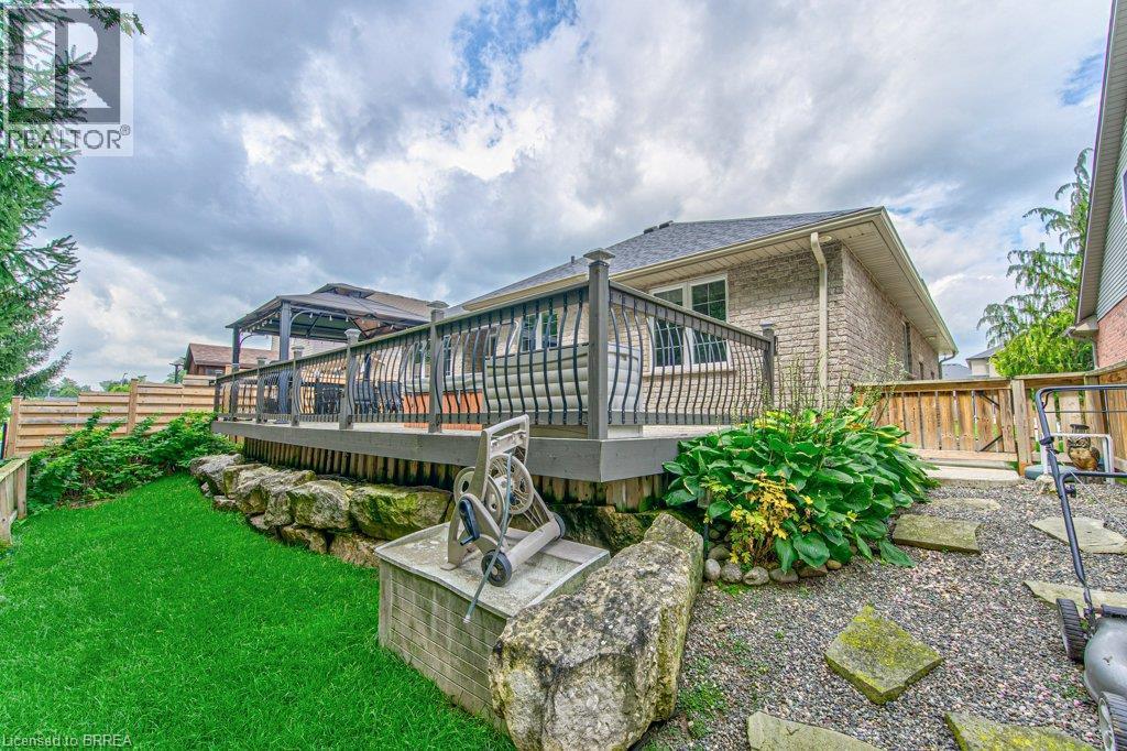 Expansive outdoor decking with dark railings, complemented by a covered gazebo - 423 Poldon Drive, Norwich, ON