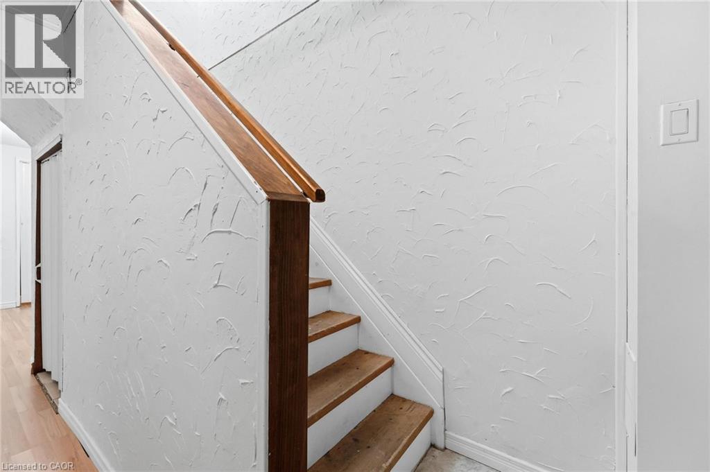 Staircase with wood treads and a coordinating wood handrail - 449 Exmoor Street, Waterloo, ON