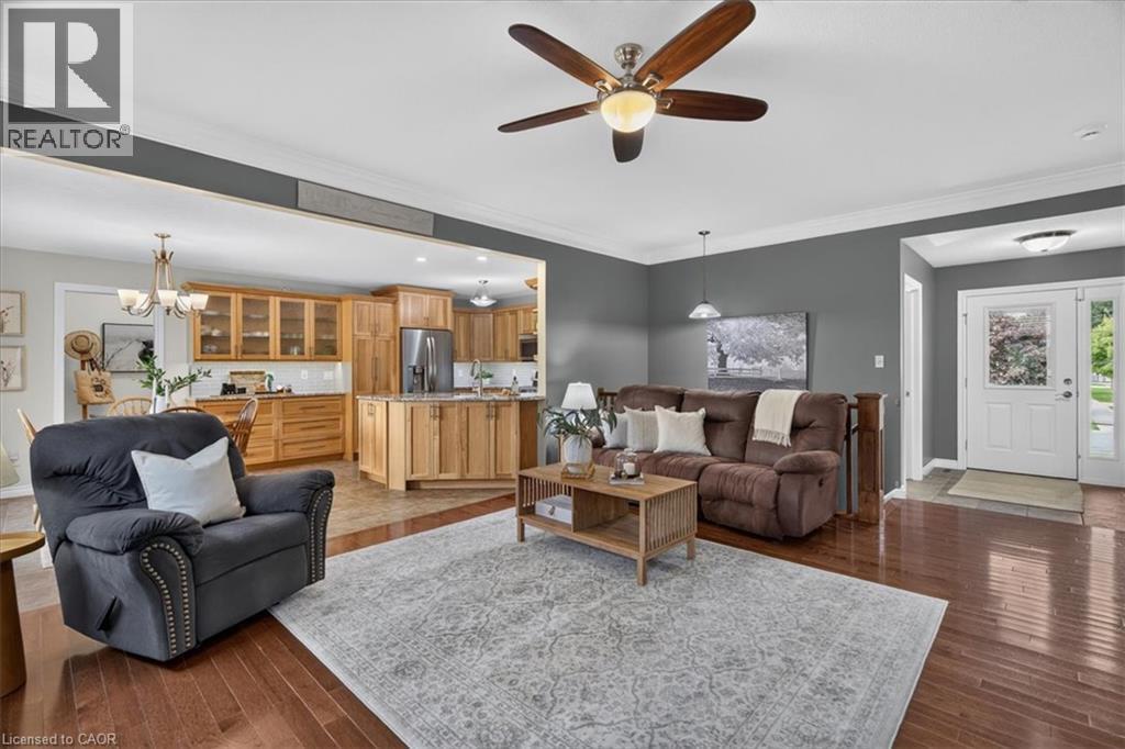 Hardwood-finish flooring, recessed lighting, and a ceiling fan with integrated lighting - 515 Woodward Drive, Mount Brydges, ON