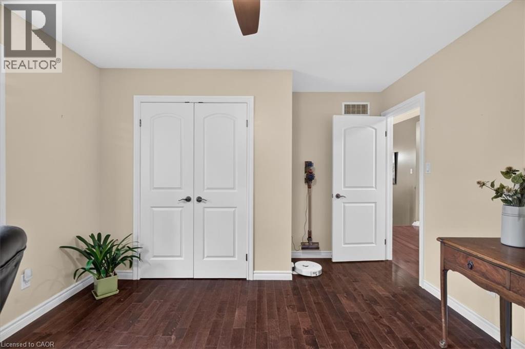 Rich wood-finish flooring with white trim - 515 Woodward Drive, Mount Brydges, ON