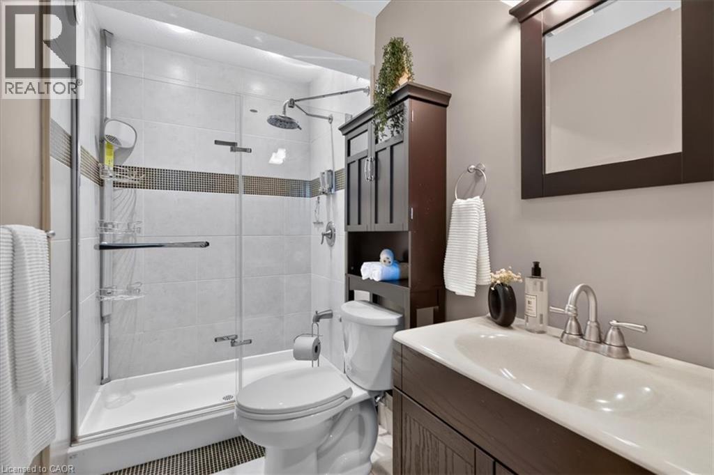 Glass-enclosed shower with tile surround and rain showerhead - 515 Woodward Drive, Mount Brydges, ON