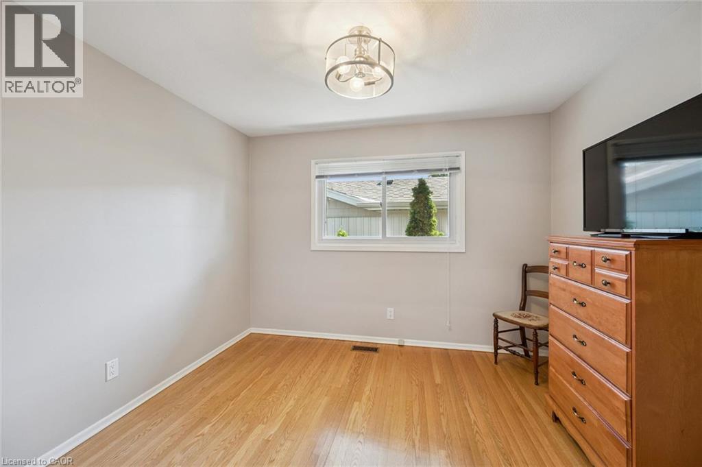 Wood-finish flooring with a flush-mounted ceiling light fixture - 35 Crosby Drive, Kitchener, ON